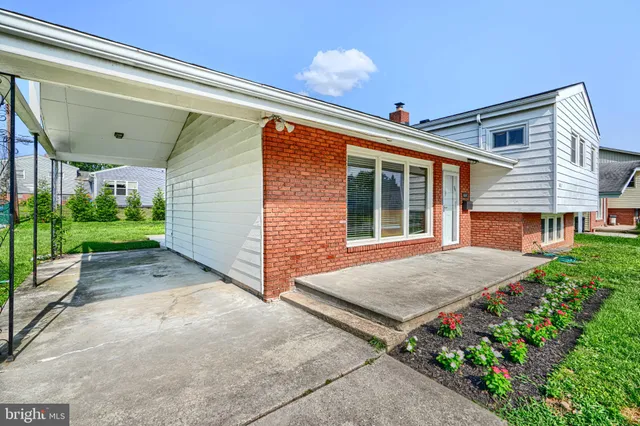 a view of a house with backyard porch and sitting area