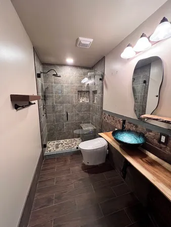 a bathroom with a double vanity sink toilet and shower