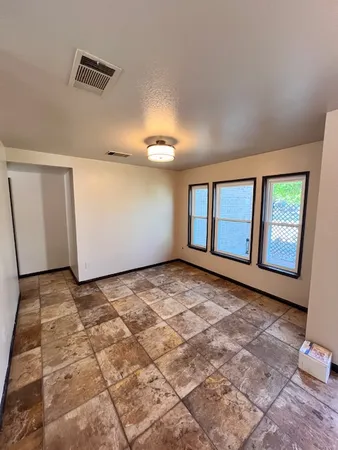 a view of an empty room with windows