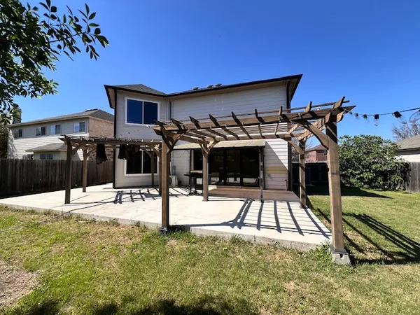 a view of a patio with table and chairs with wooden floor and fence