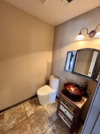 a bathroom with a toilet and a sink