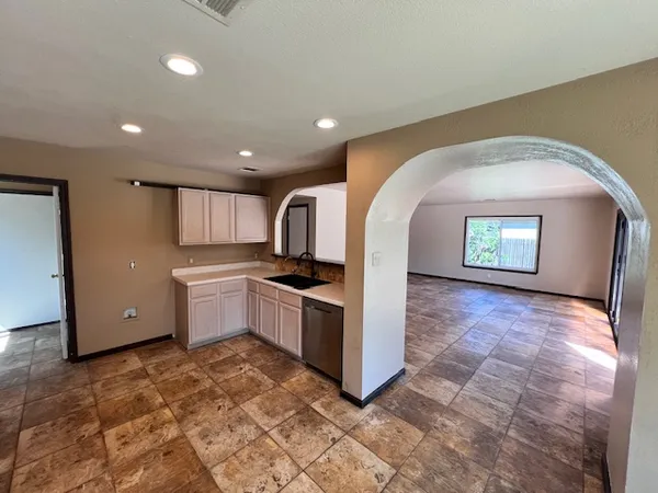 a kitchen with stainless steel appliances granite countertop a sink and cabinets