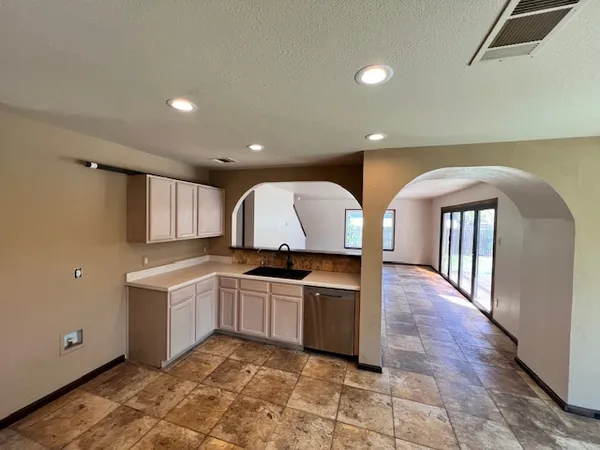 a kitchen with sink and mirror