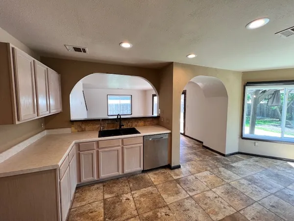 a view of a kitchen with a sink and a large window