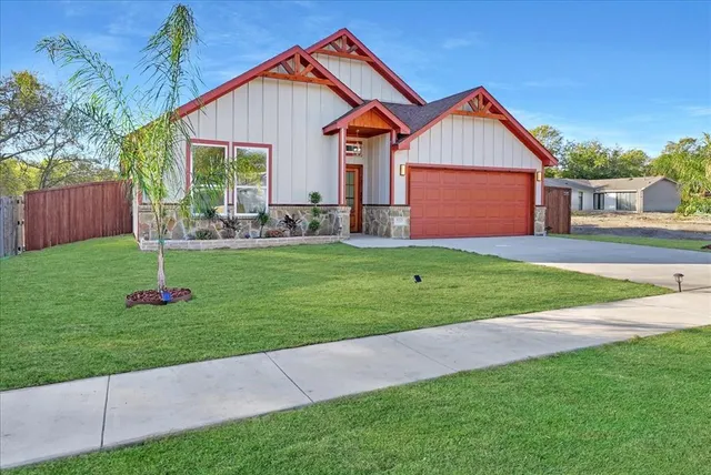 a front view of a house with a yard and porch