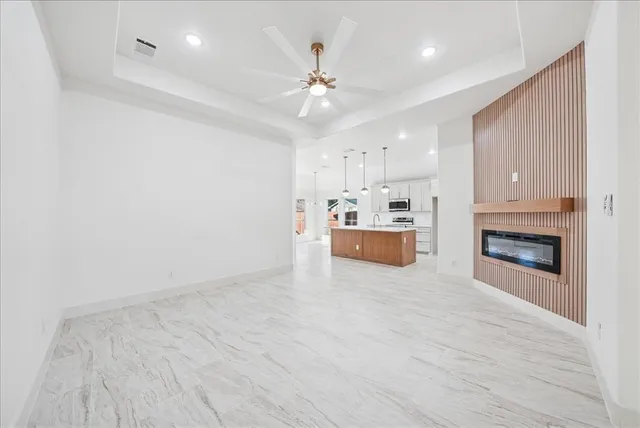 a view of a kitchen with a sink and a refrigerator