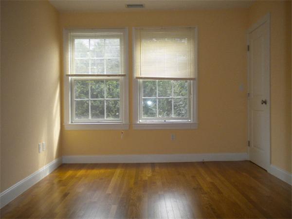 38 Fuller Street Brookline, MA 02446 - Photo 18 of 28 an empty room with wooden floor and windows
