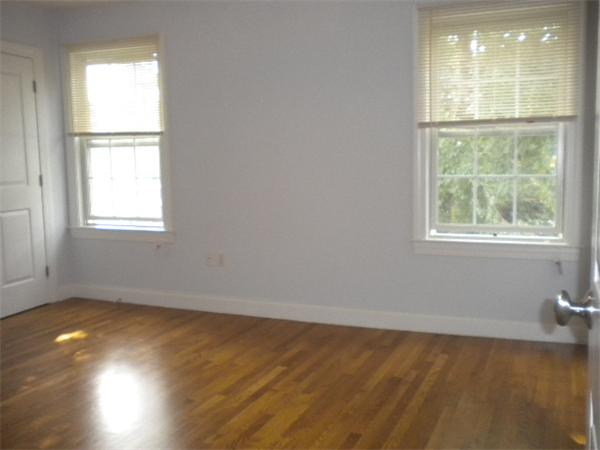 38 Fuller Street Brookline, MA 02446 - Photo 19 of 28 an empty room with wooden floor and windows