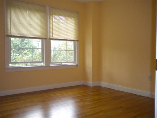 38 Fuller Street Brookline, MA 02446 - Photo 20 of 28 an empty room with wooden floor and windows