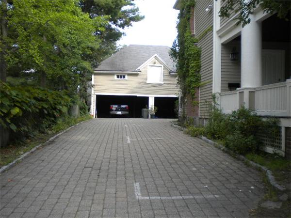 38 Fuller Street Brookline, MA 02446 - Photo 2 of 28 a front view of a house with a yard and garage