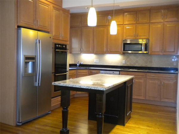 38 Fuller Street Brookline, MA 02446 - Photo 8 of 28 a kitchen with a sink a counter top space cabinets and stainless steel appliances
