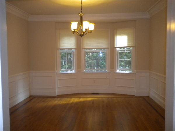 38 Fuller Street Brookline, MA 02446 - Photo 9 of 28 en empty room with windows and chandelier