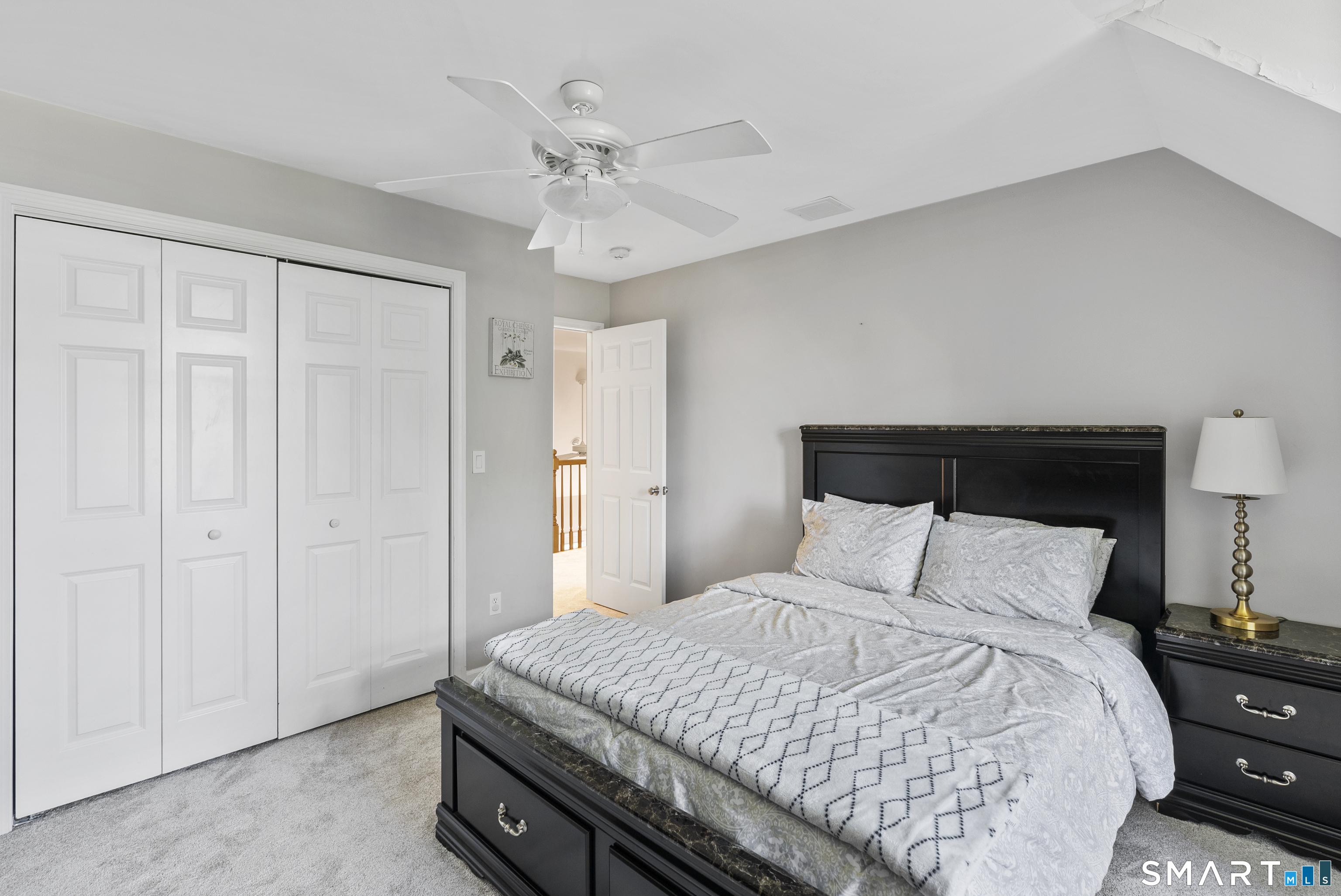 44 Farmstead Lane Suffield, CT 06078 - Photo 18 of 39 a bedroom with a bed and a chandelier