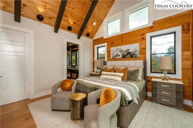 a living room with stainless steel appliances furniture a fireplace and a open kitchen view