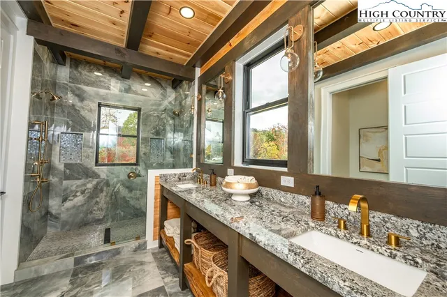 a bedroom with a bed and a view of living room