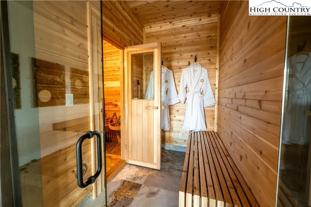 a bathroom with a granite countertop sink a mirror and shower