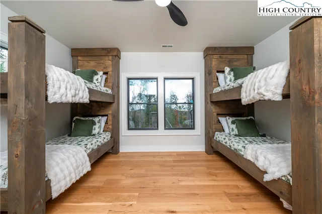 a bed sitting in a bedroom next to a window