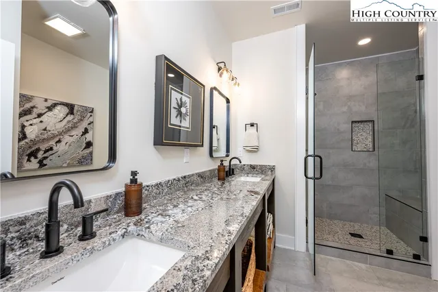 a white tub sitting in a bathroom next to a mirror