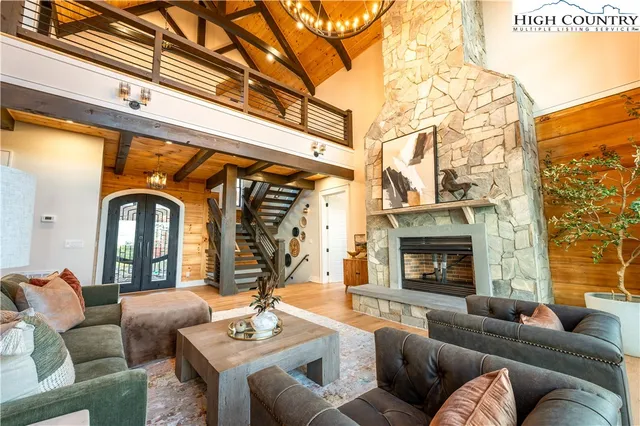 a kitchen with stainless steel appliances granite countertop a stove and a view of living room