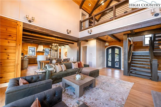 a kitchen with stainless steel appliances granite countertop a refrigerator a stove and a wooden floors