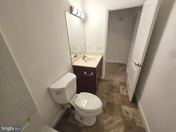 a white toilet sitting next to a bathroom sink