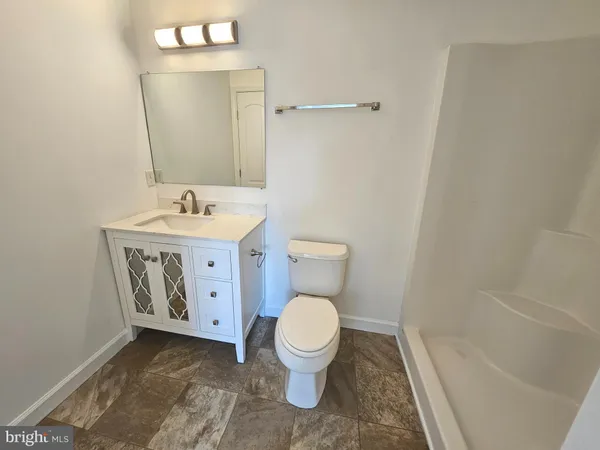 a bathroom with a toilet and shower