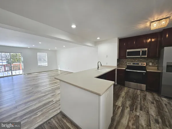 a kitchen with stainless steel appliances granite countertop a sink wooden cabinets and a granite counter tops