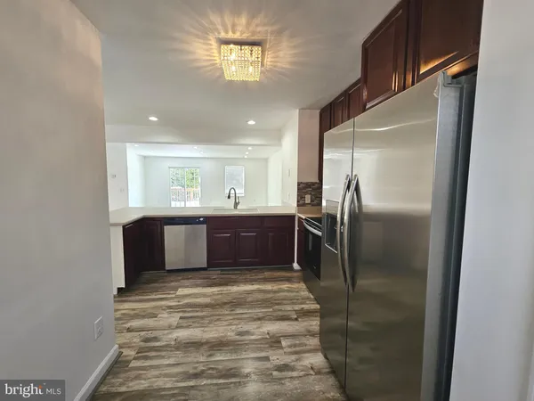 a kitchen with stainless steel appliances a refrigerator and a window