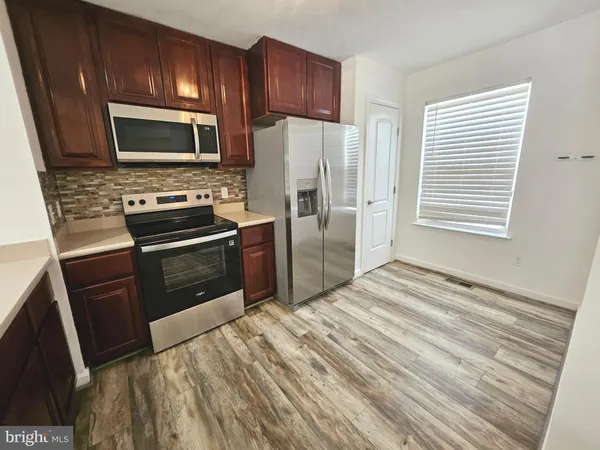 a kitchen with a refrigerator stove and microwave