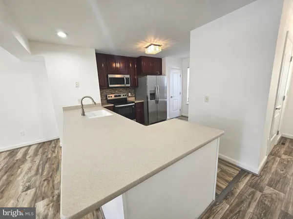a kitchen with stainless steel appliances a refrigerator sink and microwave