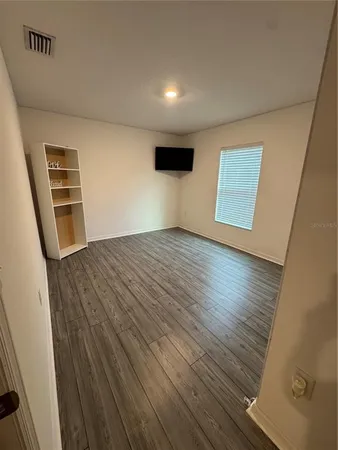 a view of an empty room and wooden floor