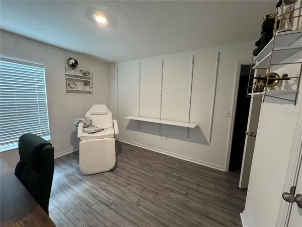 a room with wooden floor and furniture