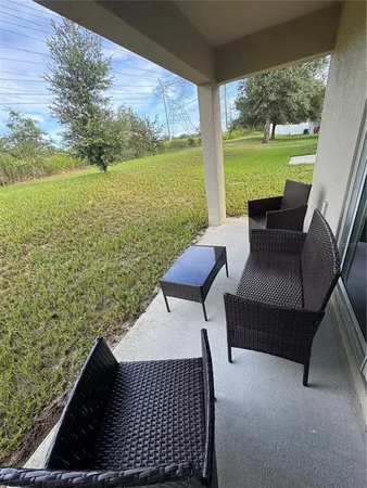 a view of swimming pool with outdoor seating and plants