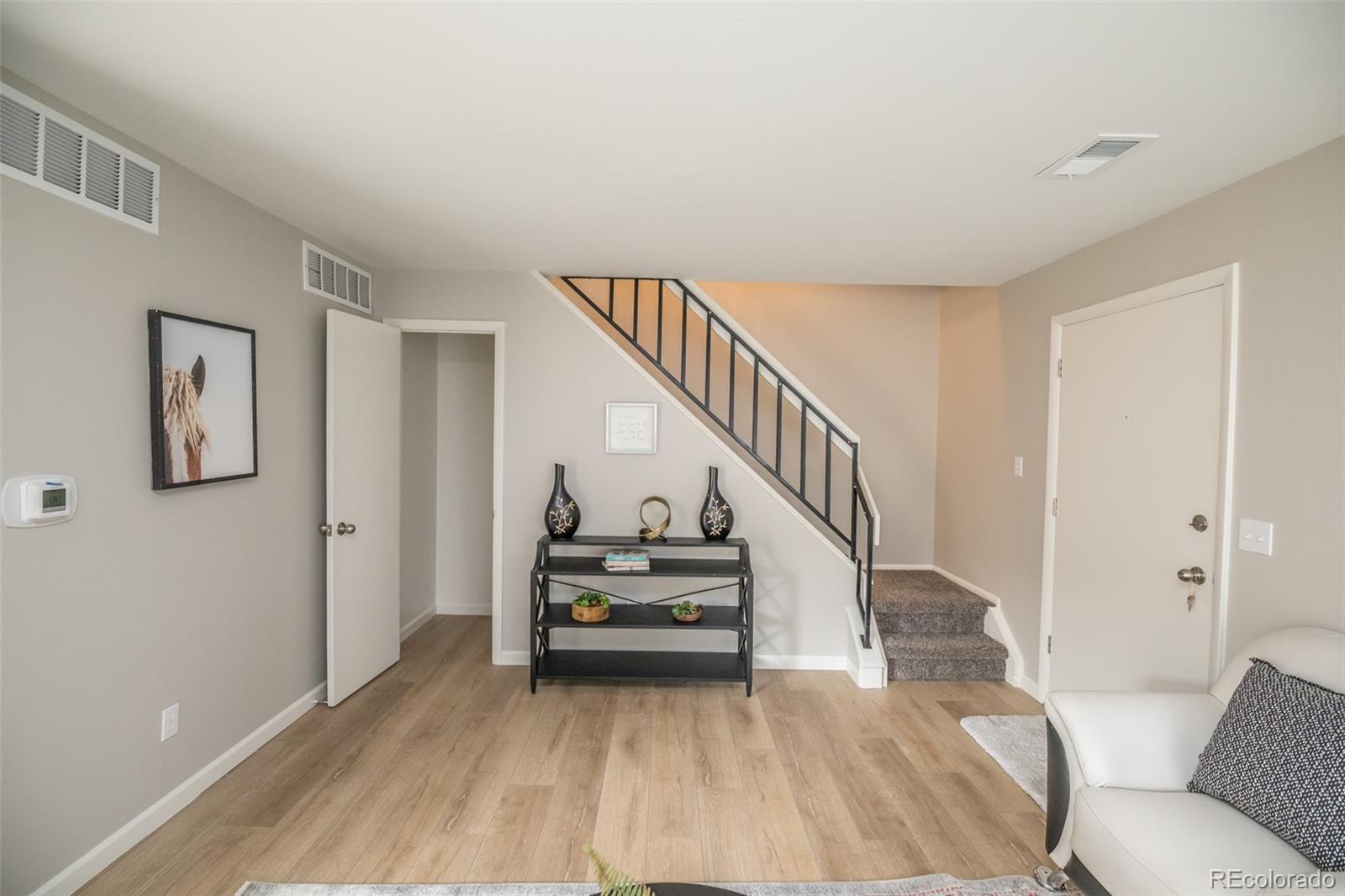 7906 Chase Circle, Unit 143 Arvada, CO 80003 - Photo 15 of 38 a view of entryway and hall with wooden floor