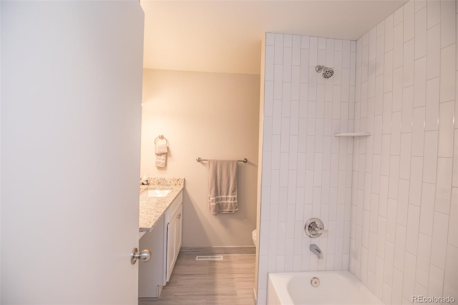 7906 Chase Circle, Unit 143 Arvada, CO 80003 - Photo 18 of 38 a bathroom with a bathtub and shower