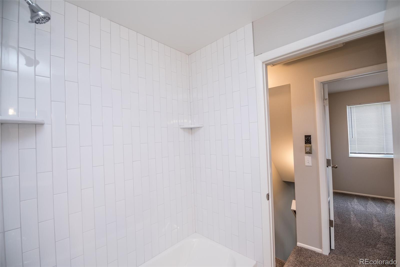 7906 Chase Circle, Unit 143 Arvada, CO 80003 - Photo 20 of 38 a view of a bathroom with a shower curtain