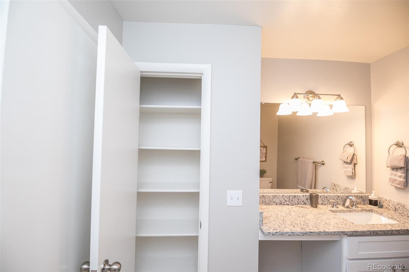 7906 Chase Circle, Unit 143 Arvada, CO 80003 - Photo 22 of 38 a bathroom with a sink and a mirror
