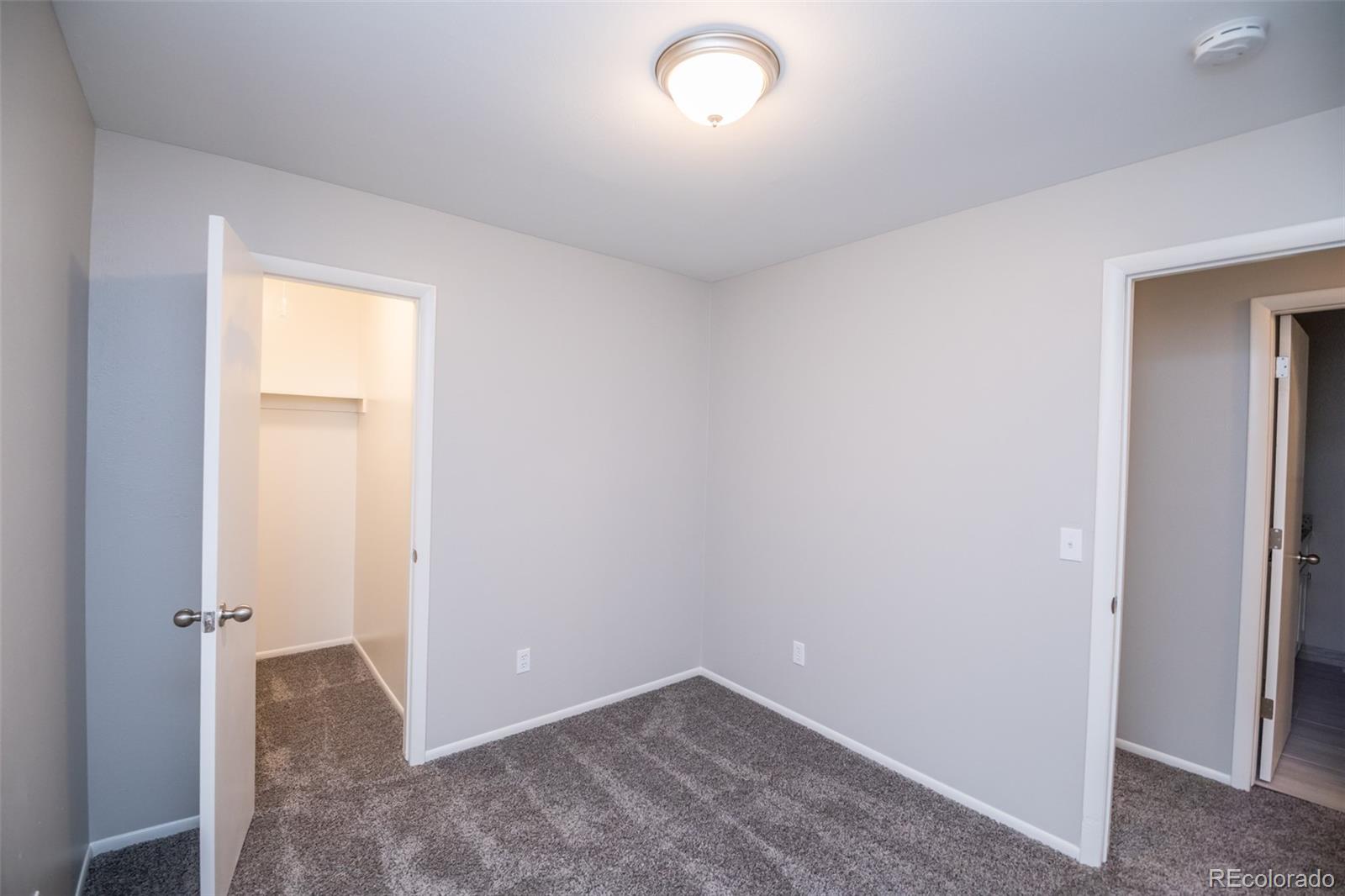 7906 Chase Circle, Unit 143 Arvada, CO 80003 - Photo 27 of 38 an empty room with closet and a bathroom