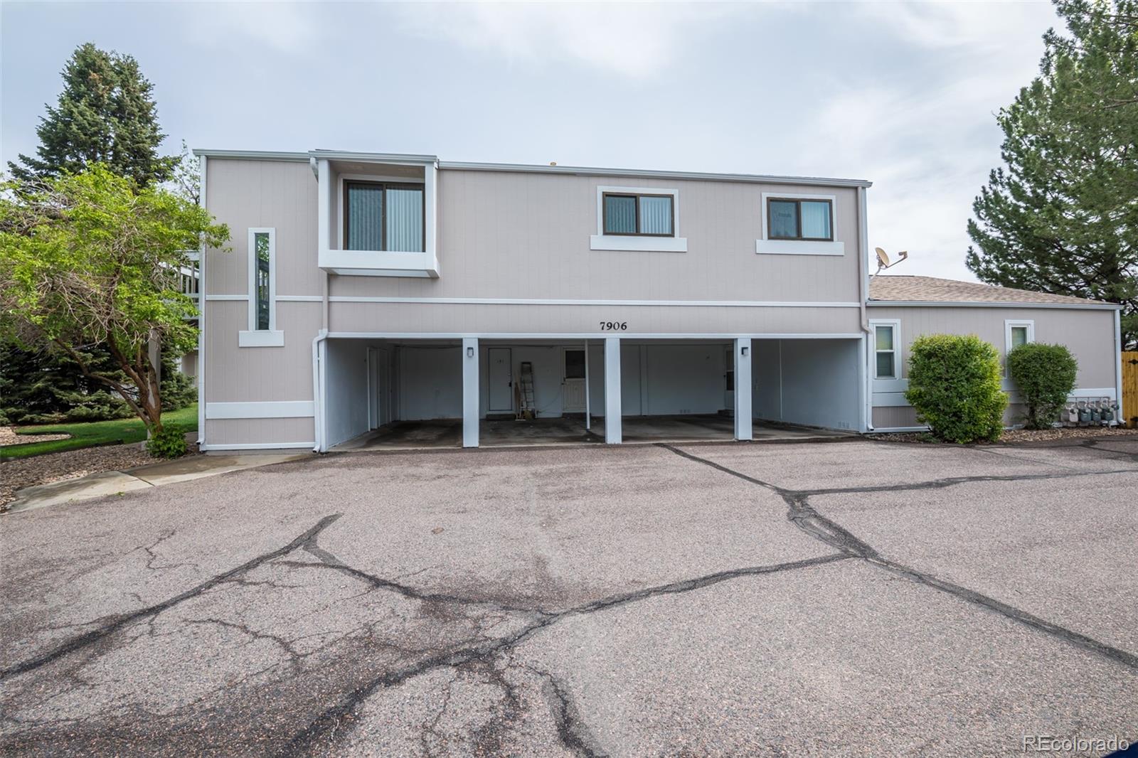 7906 Chase Circle, Unit 143 Arvada, CO 80003 - Photo 31 of 38 front view of a house with a yard and a garage