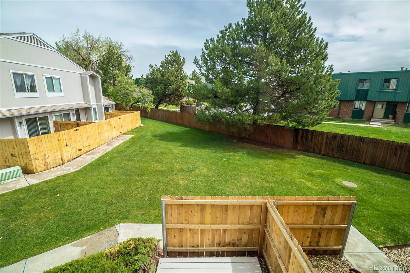 7906 Chase Circle, Unit 143 Arvada, CO 80003 - Photo 32 of 38 a backyard of a house with lots of green space