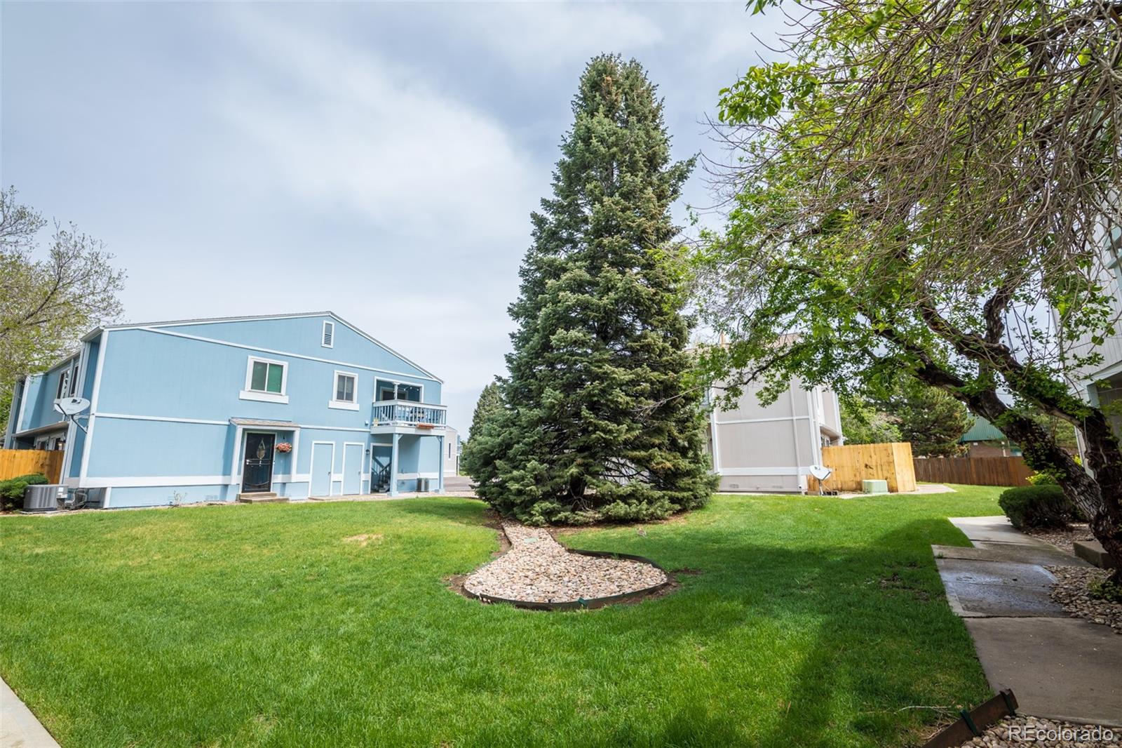 7906 Chase Circle, Unit 143 Arvada, CO 80003 - Photo 35 of 38 a front view of a house with a yard