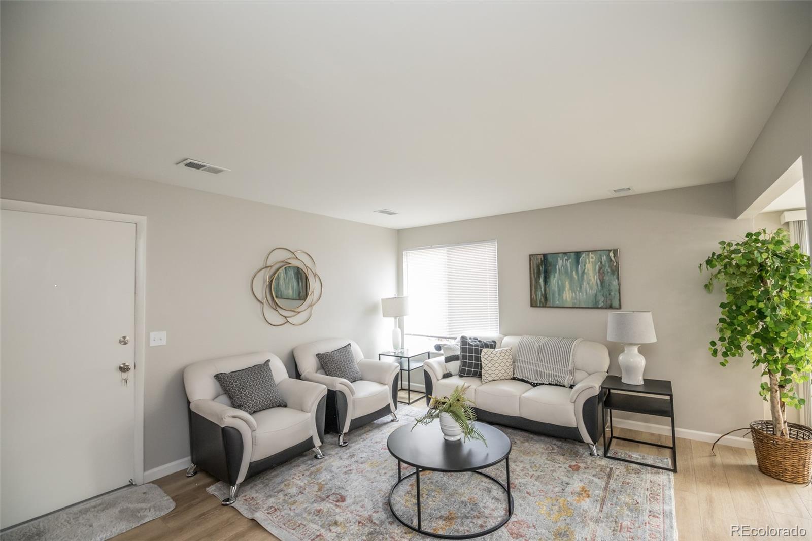 7906 Chase Circle, Unit 143 Arvada, CO 80003 - Photo 4 of 38 a living room with furniture and a large window