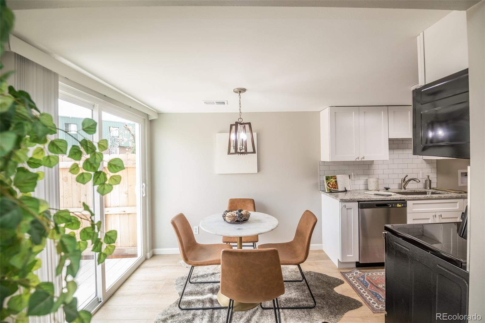 7906 Chase Circle, Unit 143 Arvada, CO 80003 - Photo 6 of 38 a view of a dining room with furniture window and outside view