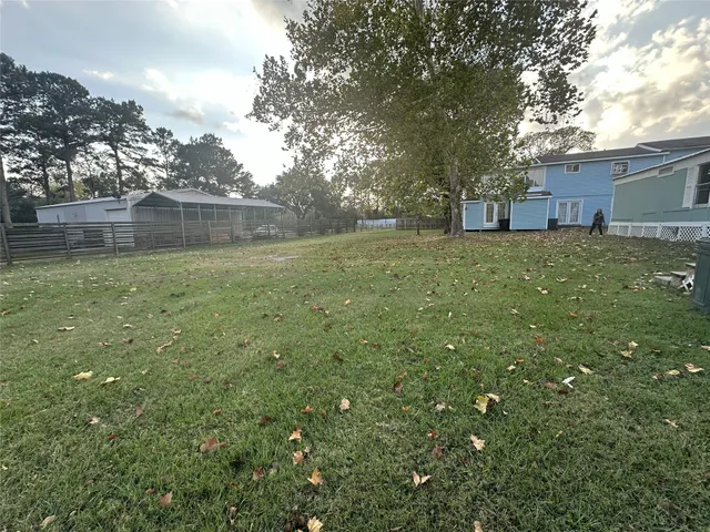 a view of a backyard with large trees