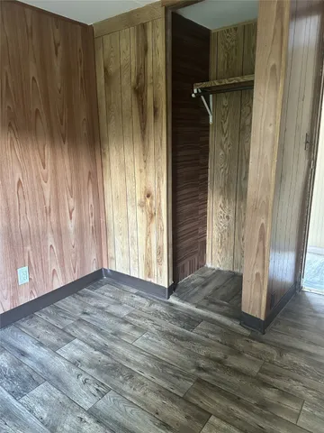 a view of an empty room with wooden door