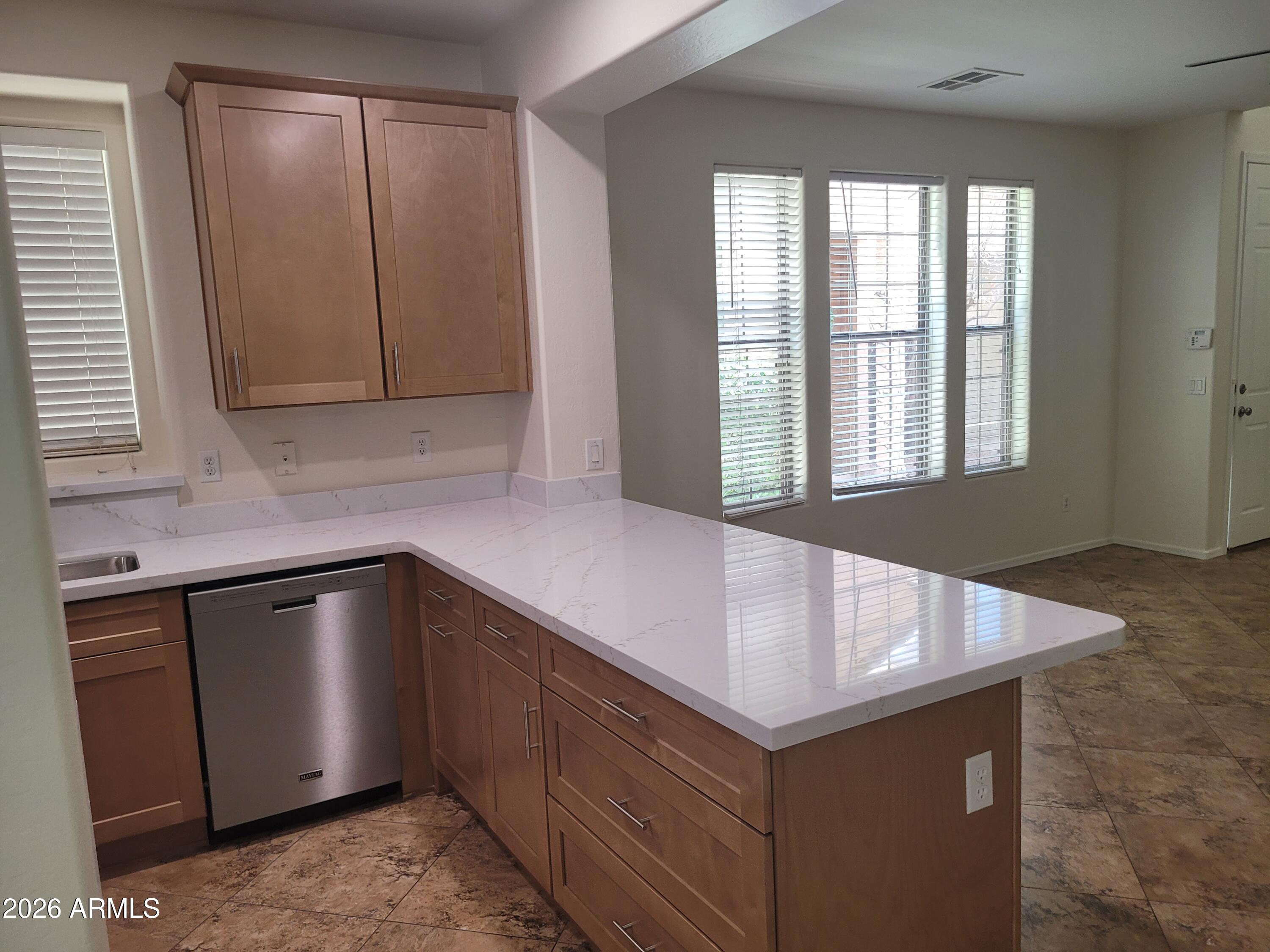 1453 South Sinova Avenue Gilbert, AZ 85296 - Photo 13 of 46 a kitchen with granite countertop cabinets and sink
