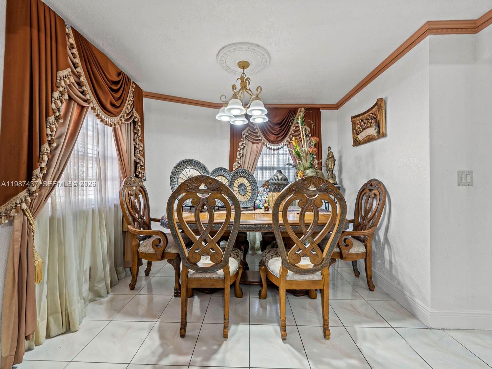 871 Southeast 5th Place Hialeah, FL 33010 - Photo 12 of 39 a view of a dining room with furniture and chandelier