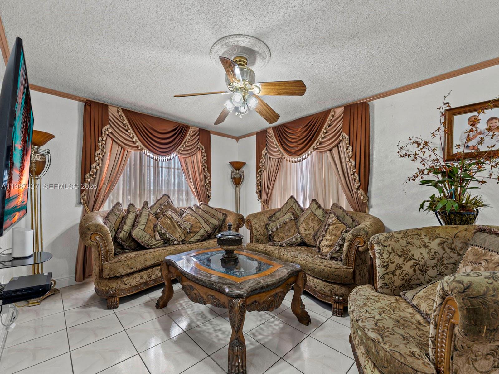 871 Southeast 5th Place Hialeah, FL 33010 - Photo 13 of 39 a living room with furniture and a ceiling fan