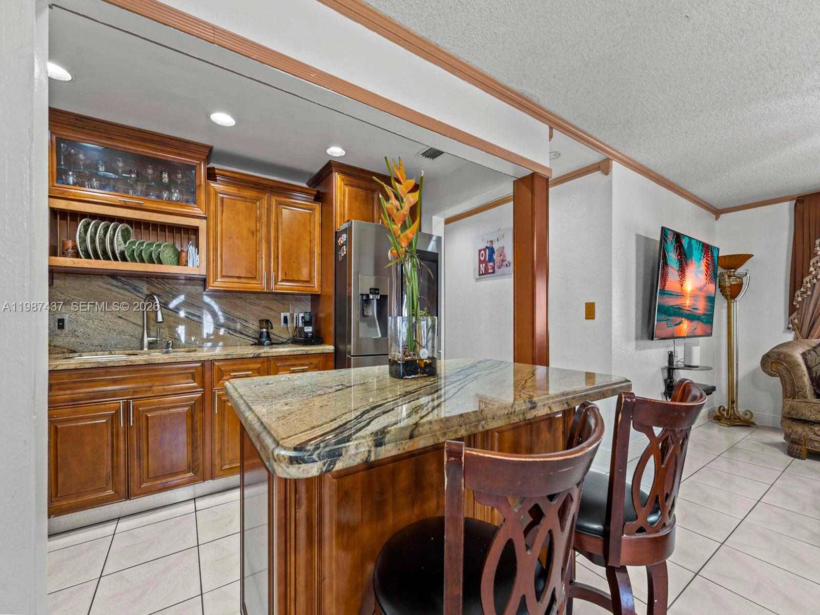 871 Southeast 5th Place Hialeah, FL 33010 - Photo 15 of 39 a kitchen with granite countertop a sink and chairs