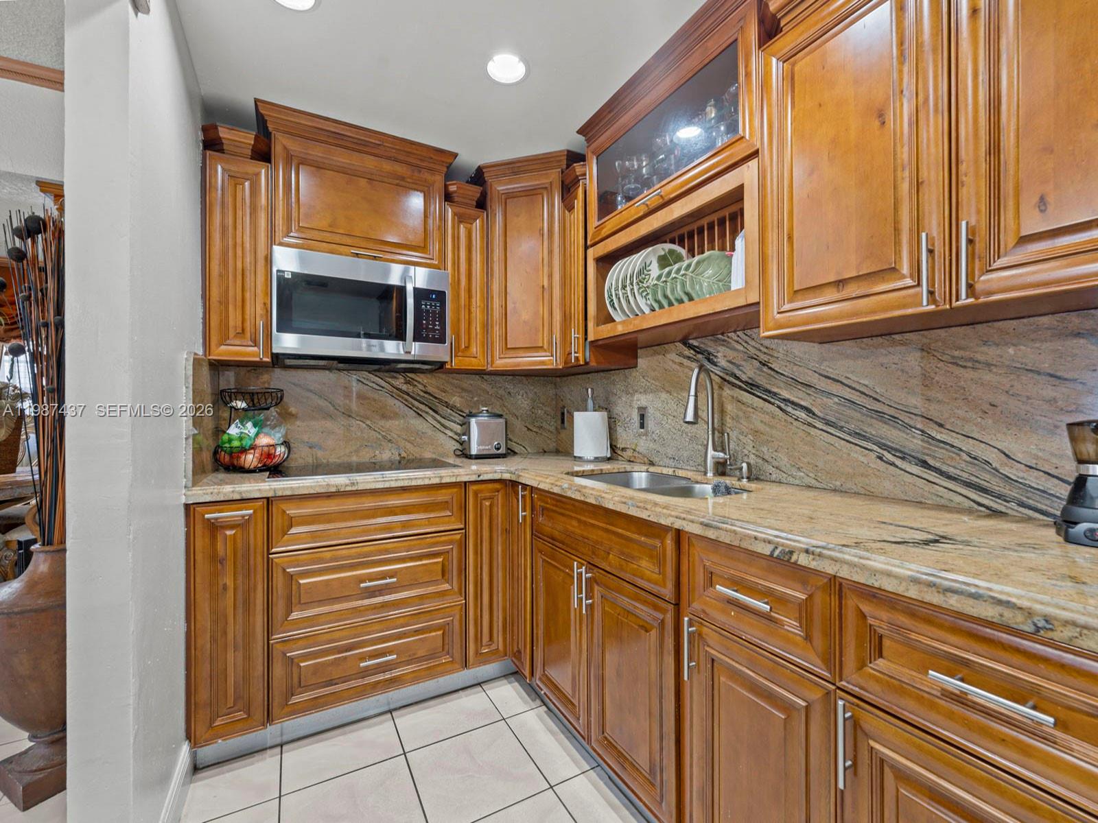 871 Southeast 5th Place Hialeah, FL 33010 - Photo 17 of 39 a kitchen with stainless steel appliances granite countertop a sink and a microwave